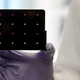 This black cartridge contains the paper-based diagnostic for detecting Zika. Areas that turn purple indicate samples infected with Zika, while yellow areas indicate samples that are free of the virus. (Image: Wyss Institute at Harvard University).